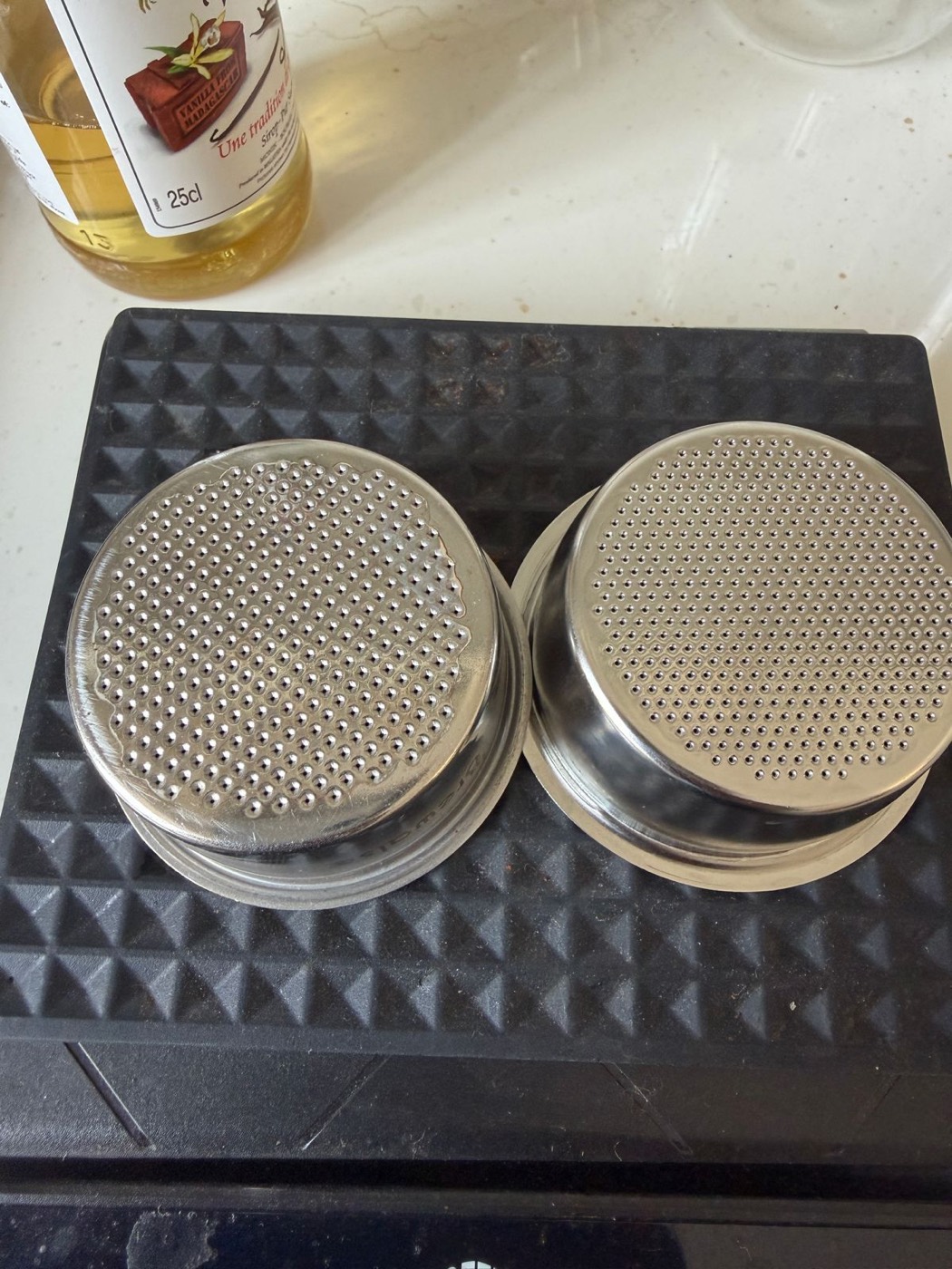 Two espresso baskets side by side — a generic basket on the left and a precision IMS basket on the right