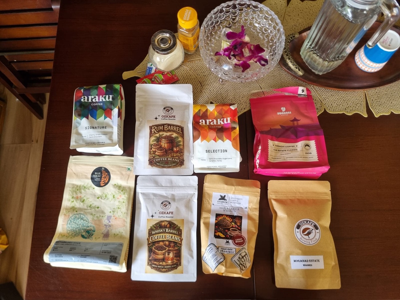 A spread of Indian coffee bean bags — Araku, Blue Tokai, Ozkafe barrel-aged, estate coffees